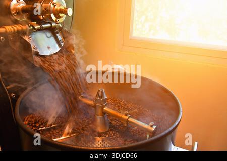Close-up of coffee beans roasting in a factory roasting machine, Thailand Stock Photo
