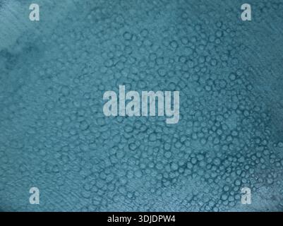 Aerial view of a sea surface, the light reflecting off the water creating a shimmering, textured effect, Stintino, Sardegna, Italy. Stock Photo