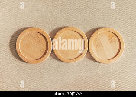 Round bamboo coasters on corduroy fabric, top view Stock Photo