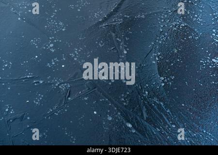 Air bubbles caotured in blue ice Stock Photo