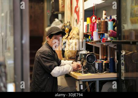 A man in a sewing shop in China town San Francisco California Stock Photo