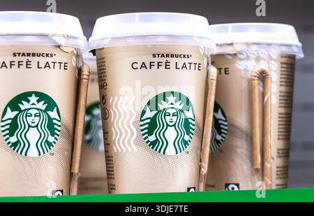 Samara, Russia - March 26, 2022: Starbucks coffee cups with Starbucks Logo ready for sale on the shelf in a superstore Stock Photo