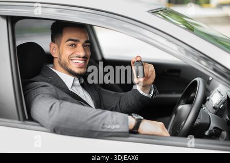 Handsome arabic businessman holding automatic car key Stock Photo