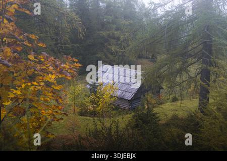 Aerial view of a rustic wooden building at the end of a cracked ...