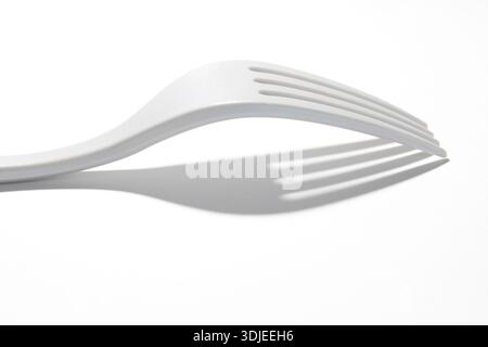 WA26994-00.....WASHINGTON - White lexan fork on white background. Stock Photo