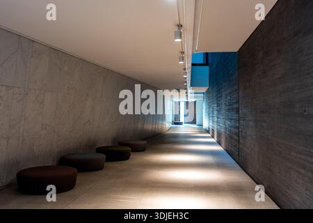 Elegant Modern Passageway Minimalist Concrete Walkway Featuring Soft Lighting And Design Elements Stock Photo
