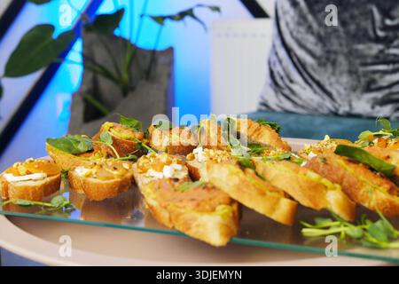 Gourmet appetizers arranged beautifully on a glass platter, showcasing fresh ingredients and vibrant colors, ideal for catering and event services Stock Photo