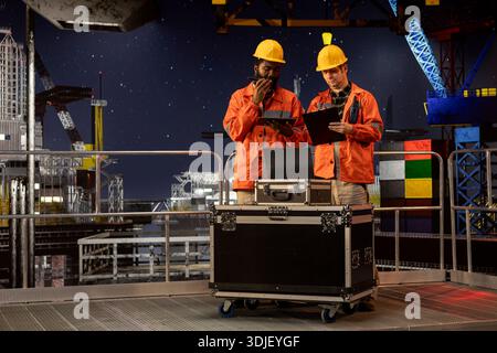 Industrial workers communicating via radio devices performing ...