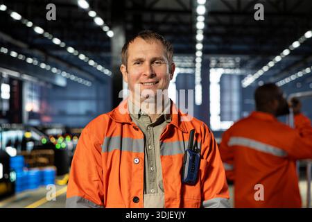 Portrait of technician oversees metal fabrication during production in workshop, highlighting heavy labor. Automation development and job responsibilities within manufacturing facility. Stock Photo