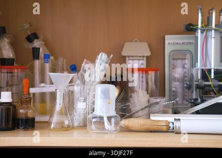 Scientific laboratory workspace displays an array of glassware, beakers, and tools, emphasizing the educational environment for students engaged in ex Stock Photo
