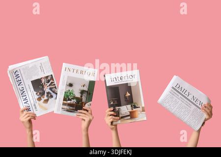 Female hands with different magazines and newspapers on pink background Stock Photo