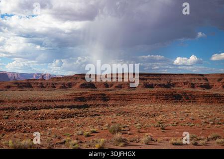 Distant Rainfall Over Red Ridge in Monument Valley, Storm Clouds, Monsoon Season, Utah USA Stock Photo