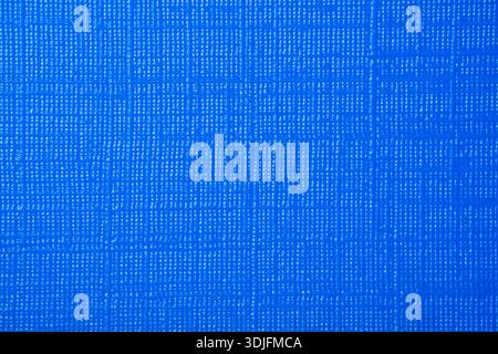 Full frame macro shot of a bright blue textured surface, featuring a cross-hatch or linen-like pattern from a book cover Stock Photo