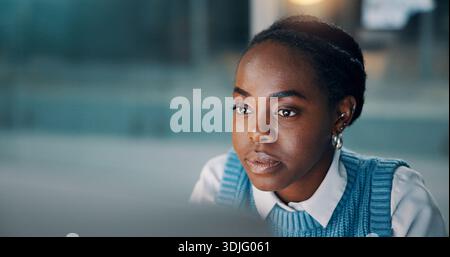 Business, black woman or reading on computer at agency for story review, proofreading draft or editing. Space, editor and serious with PC for Stock Photo