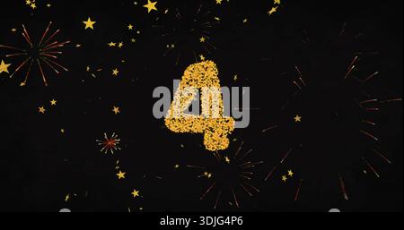 Glowing confetti numeral 4 sparkling on deep black backdrop, scattering gold stars and fireworks Stock Photo