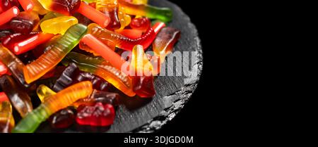 assorted jelly candies floating on black background. Stock Photo