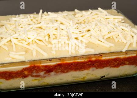 Potato and plant-based meat pie, vegan homemade dish, grated vegan cheese Stock Photo
