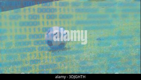 Displaying single black-white soccer ball resting on mowed grass field with blue-green scanlines Stock Photo