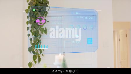 Floating blue hologram projecting charts in foyer before white door, with pothos, candle, conifer Stock Photo