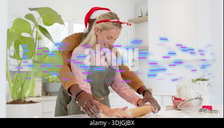 Guiding man helping woman in green apron rolling dough in kitchen, with rolling pin, purple glitch Stock Photo