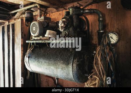 The pump of the old Miele milking machine in the cowshed at Roßalm, Chiemgau, Bavaria, Germany Stock Photo
