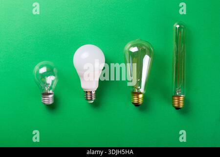 A set of different types of LED lamps isolated on a green background. Selective focus, noise. Energy-saving lamps Stock Photo