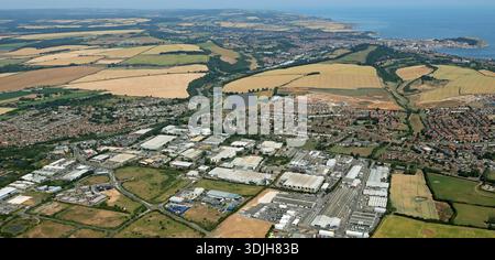 aerial view from the West of the industrial estate at Eastfield & Olympian Trading Park, with Scarborough town and the North Sea in the background Stock Photo