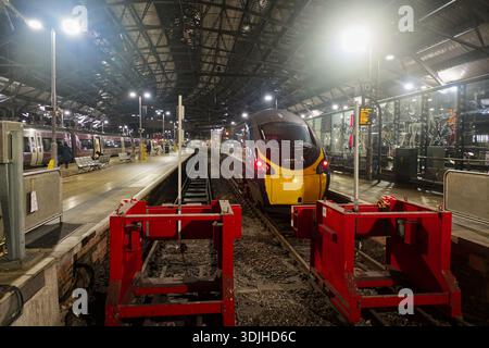 Avanti West Coast train at Liverpool Lime Street station at night, illuminated under the arched roof, ready for departure to London Euston. Stock Photo