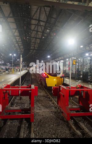 Avanti West Coast train at Liverpool Lime Street station at night, illuminated under the arched roof, ready for departure to London Euston. Stock Photo