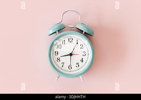 Mint Green Alarm Clock on Pink Background, Retro Style Desk Clock Showing Time. Stock Photo