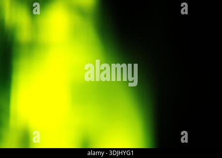 Blurred green magical light effect on black background. Stock Photo