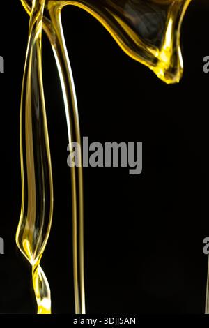 Abstract oil splashes and drips isolated on black for luxury design. Stock Photo