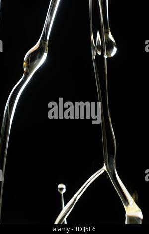 Abstract oil splashes and drips isolated on black for luxury design. Stock Photo