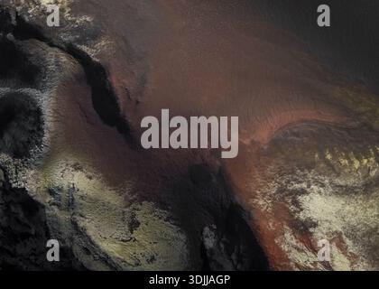 Aerial view of dramatic earth tones blend in an ethereal dance of textures, creating a mesmerizing landscape, Myvatn, Þingeyjarsveit, Iceland. Stock Photo