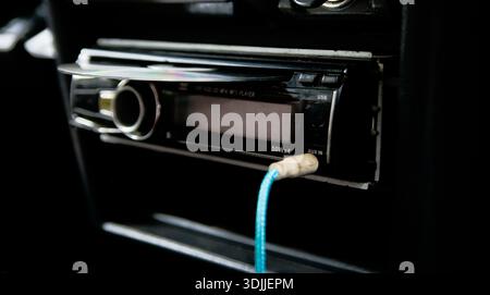 close up of dvd player with disc on head unit audio old car Stock Photo