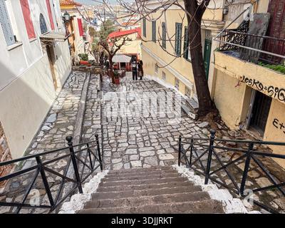 Plaka (Πλάκα), Athens, Greece. Historic district with picturesque stone-paved street (kalderimi) and steep stairs leading down from the Acropolis area Stock Photo