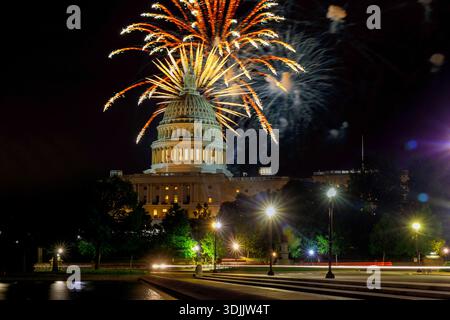 Fireworks burst above Capitol building as people enjoy celebration on Independence day night in Washington D.C. Stock Photo