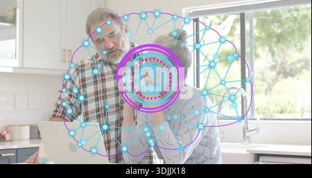 Standing senior couple in sweater and plaid-shirt using open laptop at kitchen counter AI graphic Stock Photo