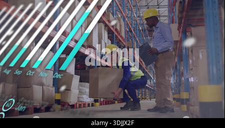 Squatting worker lifting box while manager holding clip in warehouse with overlay, wearing vest Stock Photo