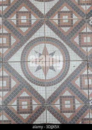 Ceramic floor tiles. Tiling, pavement, surface covering. Repeating geometric pattern with star design. Background texture. Stock Photo