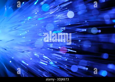 Blue and light blue fiber filaments with bright points of light and multicolored highlights Stock Photo