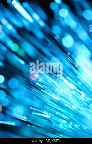 Optical fibres dinamic flying from deep on technology abstract background Stock Photo
