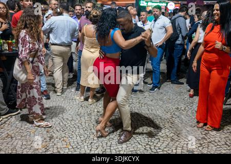 A couple dances at a roda de samba in Cinelândia, downtown Rio de Janeiro, Brazil, during a lively nighttime street gathering. Stock Photo