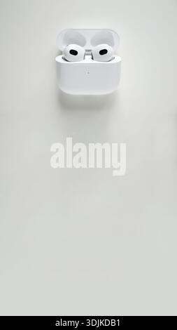 wireless-earbuds-inside-an-open-charging-case-on-white-background-stock