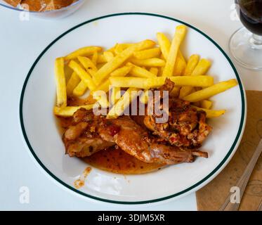 Braised rabbit served with potato garnish Stock Photo