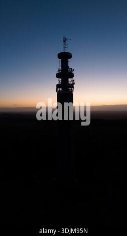 Drone photograph showing the Pye Green BT Tower in full silhouette during sunset in England, United Kingdom, Staffordshire Stock Photo