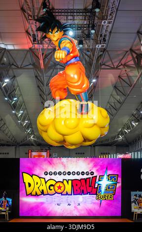 chiba, makuhari - jan 25 2026: A giant Japanese Goku balloon floats on a Nimbus above posters for the Beerus movie at the free Dragon Ball Genkidamats Stock Photo