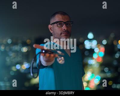 Medical professional offering a stethoscope with blurred city lights in the background Stock Photo