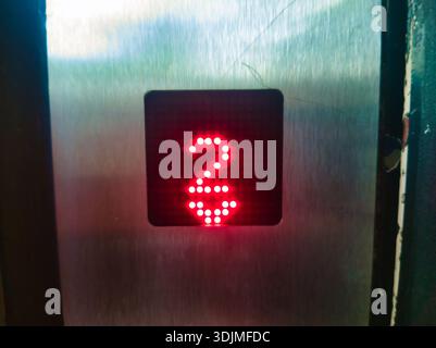 Close up of a digital elevator display in Ors vezer tere, Budapest. The red LED shows the number two with a downward arrow on a brushed metal panel. C Stock Photo