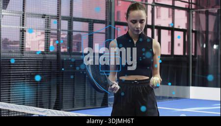 Holding racket and ball, woman wearing black athletic gear standing on blue court with AR padlock Stock Photo